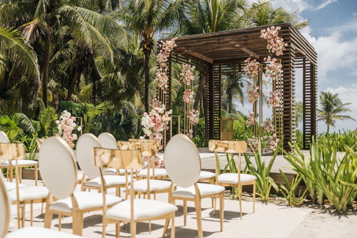 Outdoor destination wedding venue with floral ceremony decor